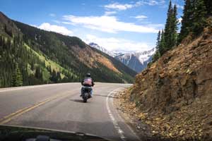 A biker riding up a scenic mountain
