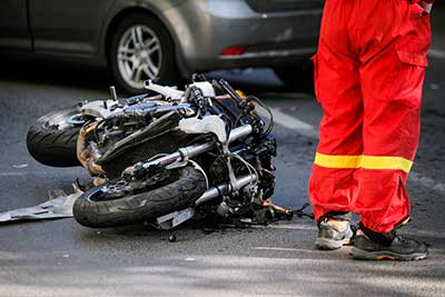A motorcycle crashed laying on it's side in road