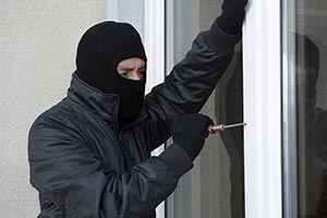 A buglar breaking into a mobile home