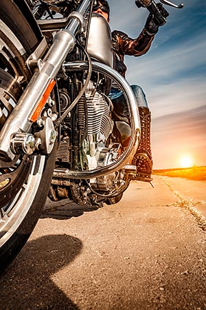 A motorcycle rider riding in the early morning