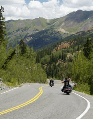 Two motorcyclist riding on winding mountain road