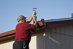 A mobile home owner checking roof and gutters