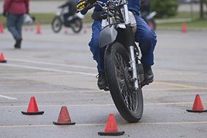 A motorcycle running through an obstacle course.