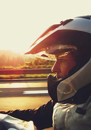 Motorcyclist sitting on motorcycle wearing black leather