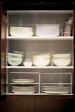 Cabinet filled with dishes and bowls