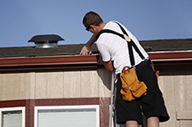 A mobile home owner checking roof and gutters