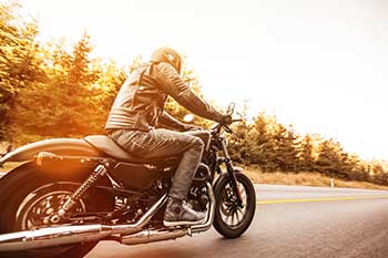 Motorcyclist riding on motorcycle wearing black leather